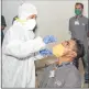  ??  ?? A health worker takes nasal swab sample from a person at a residentia­l complex in Malad East on Friday. (Photo: BL Soni)