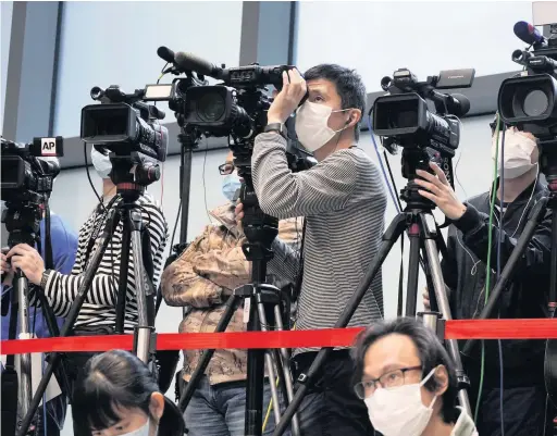  ??  ?? Reporters wearing masks attend a press conference with Hong Kong chief executive Carrie Lam in Hong Kong