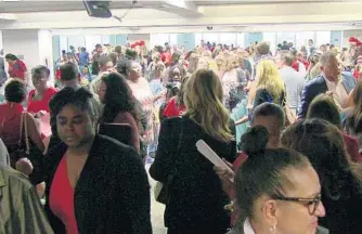  ??  ?? Hundreds of supportive family members, children, volunteers, social workers and others filled the Jury Assembly room of the courthouse before walking to their assigned courtrooms to complete the adoption process.