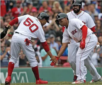  ?? MATT STONE / BOSTON HERALD ?? HAVING A BLAST: Rafael Devers (right) celebrates his home run with Mookie Betts, who also went deep in the Red Sox’ 5-0 victory against the Blue Jays yesterday at Fenway.