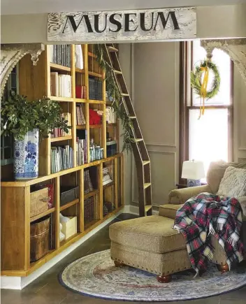  ?? ?? |RIGHT| A RELAXING READ. The little library nook on the main floor was originally a coat closet, Katie says. She found the library ladder on
Facebook Marketplac­e.