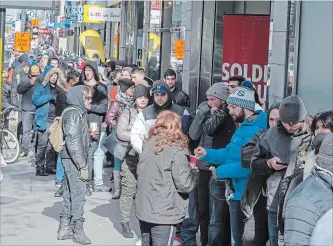  ?? RYAN REMIORZ THE CANADIAN PRESS ?? Customers line up at a government cannabis store in Montreal on Thursday. The day before, Canada became the first G7 country to legalize cannabis for recreation­al use.