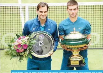  ?? — AFP ?? HALLE: Borna Coric (R) from Croatia poses with Roger Federer of Switzerlan­d after defeating him in their final match at the ATP tennis tournament in Halle, western Germany, yesterday.