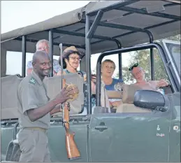  ??  ?? Fhumulani Sidney Mikosi introduces his game drive clients to dung beetles.