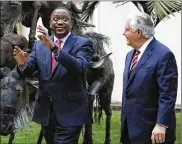 ?? JONATHAN ERNST / AP ?? Kenya’s President Uhuru Kenyatta (left) walks with U.S. Secretary of State Rex Tillerson after meeting Friday in Nairobi, Kenya. Chinese workers, not Africans, could get constructi­on jobs, U.S. officials warn.