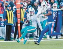  ?? MATT DURISKO/AP ?? Dolphins safety Jevon Holland, pictured returning an intercepti­on during an NFL wild-card playoff game on Jan. 15, is one of the young players new defensive coordinato­r Vic Fangio is excited to coach.