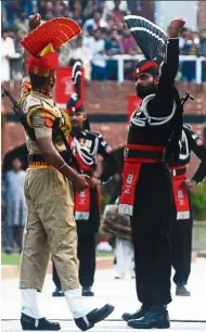  ?? —AFP ?? Indian Border Security Force guard (left) and Pakistani Rangers taking part in the daily retreat ceremony at Wagah Border near Amritsar.