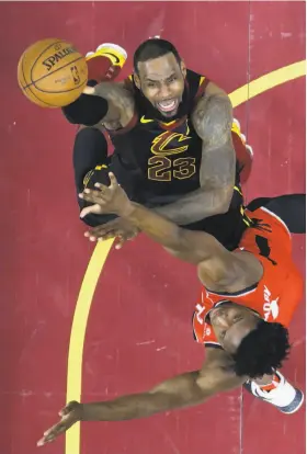  ?? Tony Dejak / Associated Press ?? The Cavs’ LeBron James shoots against the Raptors’ OG Anunoby in the first half of Game 4 in Cleveland. James had 29 points, eight rebounds and 11 assists.