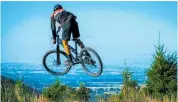  ??  ?? A cyclist gets some air at Arapuke Mountain Bike Park.