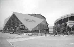  ?? AP Photo/John Bazemore ?? n Mercedes Benz Stadium, left, the new home of the Atlanta Falcons football team and the Atlanta United soccer team, is shown Tuesday next to the Georgia Dome in Atlanta, Ga.