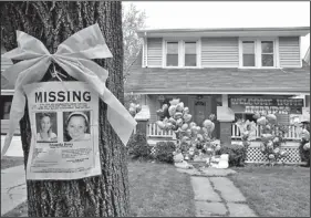  ??  ?? A missing poster rests on a tree outside the home of Amanda Berry, in Cleveland, Ohio, in May. Ariel Castro, 53, serving a life sentence for the kidnapping and rape of Berry and two other women, was found hanging in his cell Tuesday night.