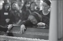  ?? YURIY DYACHYSHYN/AFP VIA GETTY IMAGES ?? The mother of Yuriy Huk, a Ukrainian serviceman killed during the Russian invasion, mourns at his funeral service at the Saints Peter and Paul Garrison Church in the western Ukrainian city of Lviv on Monday.