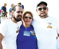  ?? The El Paso Times via AP ?? LEFT:
Martha Aguilar greets sons Juan Francisco Loya, left, and Oscar Loya, right, June 24 in the Rio Grande riverbed. Aguilar lives in El Paso, while her sons live in Juarez, Mexico. Aguilar had not seen Juan Franciso for eight years and Oscar for 12...