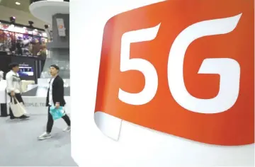  ?? - Bloomberg photo by SeongJoon Cho ?? Displays promote 5G technology at the World IT Show 2018 in Seoul last month.