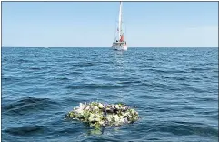  ??  ?? A wreath from his old school floats in the Moray Firth yesterday in the seas where Prince Philip learned to sail