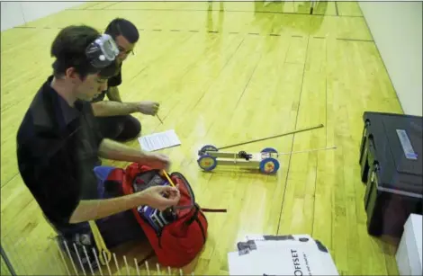  ?? BRADY TUCKER - DIGITAL FIRST MEDIA ?? Nearly 350 students from 19 different schools competed in the Berks County Science Olympiad at Kutztown University on Jan. 11. Some events included helicopter­s, hovercraft, mousetrap vehicle, rocks and minerals, and chemistry lab. Pictured are Justin...