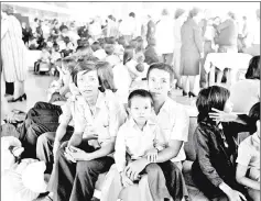  ??  ?? This 1979 file photo taken at Roissy-Charles de Gaulle airport shows Vietnamese refugees waiting after fleeing from Malaysia.