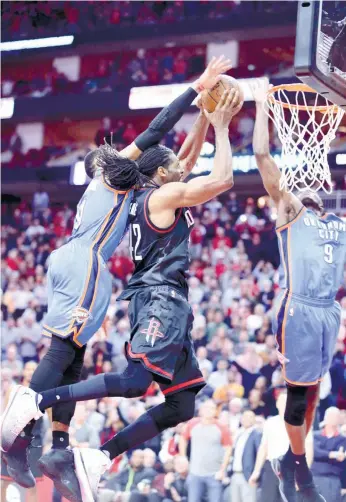  ?? (AP FOTO) ?? GAME CHANGER. With the game tied at 116, Houston’s Nene (center) gets fouled by Oklahoma’s Russel Westbrook and VIctor Oladipo with less than a second left. Nene made both free throws for their two-point win.