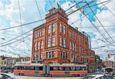  ?? GETTY IMAGES ?? “Red Rocket” streetcars rumble past The Broadview Hotel, which opened last year in Toronto.