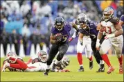  ?? ROB CARR / GETTY IMAGES ?? Unheralded rookie Gus Edwards finished with 104 yards in Baltimore’s 20-12 win Sunday vs. Tampa Bay. The Ravens rushed for 242 yards on 49 attempts.