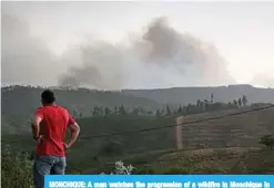  ??  ?? MONCHIQUE: A man watches the progressio­n of a wildfire in Monchique in the Portuguese Algarve. —AFP