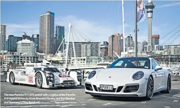  ?? Picture / Matthew Hansen ?? The new Porsche 911 GTS posed with a replica of the Porsche 919 Hybrid driven by Kiwis Brendon Hartley and Earl Bamber and Germany's Timo Bernhard.