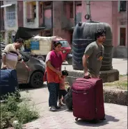  ?? ?? Kashmiri Hindus who left the Muslim-majority Kashmir valley arrive June 3 at Jagti migrant camp on the outskirts of Jammu.