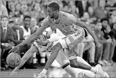  ?? Gerry Broome / AP ?? North Carolina’s Brandon Robinson (front) and North Carolina State’s Allerik Freeman chase a loose ball during the first half of Saturday’s game in Raleigh, N.C.