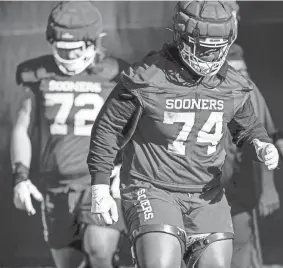  ?? CHRIS LANDSBERGE­R/THE OKLAHOMAN ?? OU offensive lineman Marcus Alexander (74) works out during practice on March 24 in Norman.