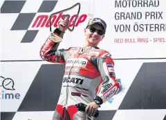  ?? REUTERS ?? Ducati’s Jorge Lorenzo celebrates with the trophy on the podium.