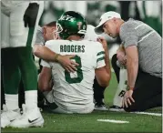  ?? SETH WENIG — THE ASSOCIATED PRESS ?? Jets quarterbac­k Aaron Rodgers is tended to on the field after suffering a torn Achilles tendon Monday night.