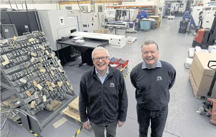  ??  ?? HANG ON TO THE KIT: Owner and managing director Stephen Cheetham, left, stands with his chief engineer on the shop floor at PK Engineerin­g in Hereford. Mr Cheetham has a disaster plan for Brexit.
