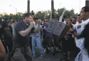  ?? Leah Millis / The Chronicle 2016 ?? A Trump supporter gets in a fighting stance amid a tiff with protesters at a June 2016 rally in San Jose.