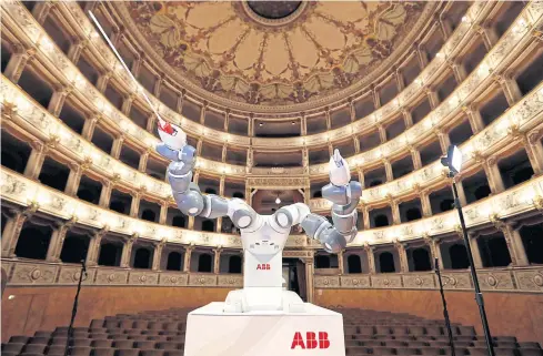  ?? REUTERS ?? Humanoid robot YuMi is seen during a rehearsal at the Verdi Theatre in Pisa, Italy last year. YuMi conducted the Lucca Philharmon­ic Orchestra, performing a concert with tenor Andrea Bocelli.