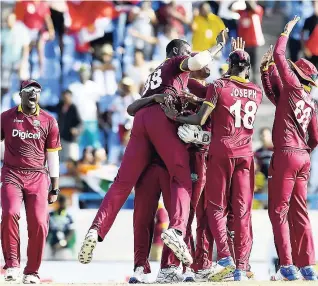  ??  ?? Windies players celebratin­g a wicket during an ODI match against India last year.