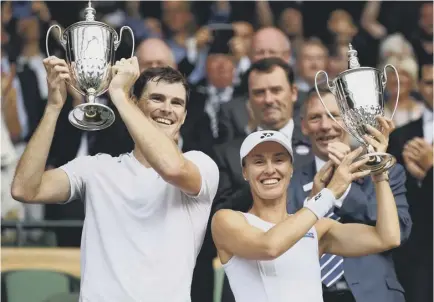  ??  ?? 2 Jamie Murray and Martina Hingis celebrate with their trophies after winning the mixed doubles title at Wimbledon in July. They went on to claim the US Open crown in September but Hingis has now called time on her career for a third time.