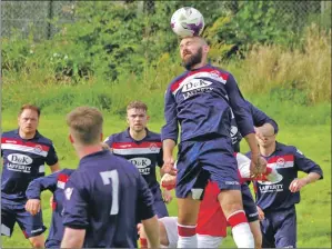  ?? Photos: Derek Black ?? Oban Saints defender Jamie Graham heads clear during the final.