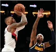  ?? STEVE DYKES — GETTY IMAGES ?? The Trail Blazers’ Damian Lillard, left, fires a shot over Denver’s Torrey Craig during Game 4on Sunday in Portland.