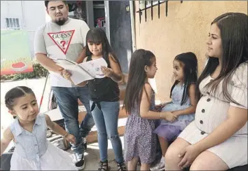 ?? Genaro Molina Los Angeles Times ?? MARIA REYES, right, and her husband, Moises Bahena, with their four daughters. Four-year-old Darlene, second from right, will begin preschool remotely, learning her ABCs on an iPad she shares with her sister.