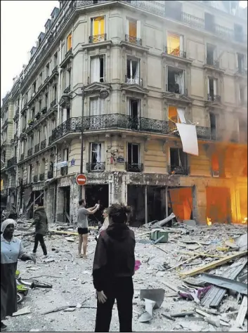  ?? Matthieu Croissande­au The Associated Press ?? Debris covers an intersecti­on in Paris following a deadly explosion at a bakery.