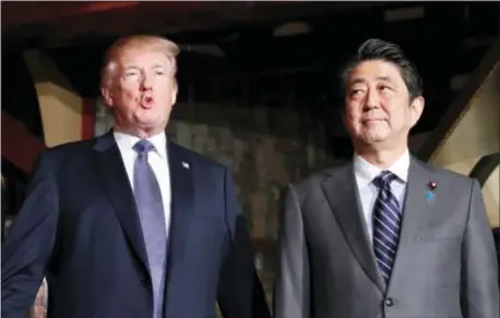  ?? KIM KYUNG-HOON/POOL PHOTO VIA AP ?? U.S. President Donald Trump, accompanie­d by Japanese Prime Minister Shinzo Abe, speaks to members of the media before having a dinner at Ginza Ukai Tei restaurant, Sunday, Nov. 5, 2017, in Tokyo.