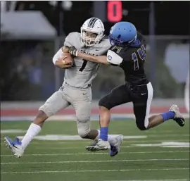  ?? RESEDA WIDE RECEIVER Gina Ferazzi Los Angeles Times ?? Zecharriah Gipson tries to break a tackle by Crenshaw defensive back Andrew Wynn during the first half at Crenshaw.