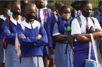  ??  ?? Students returning to school in Harare