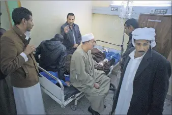  ?? [AMR NABIL/THE ASSOCIATED PRESS] ?? Relatives of Sheikh Sulieman Ghanem, 75, surround him Friday as he receives medical treatment at the Suez Canal University hospital in Ismailia, Egypt. Ghanem was among those injured in the attack on a mosque.