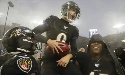  ??  ?? Justin Tucker is carried off field by his teammates after his game winning field goal. Photograph: Julio Cortez/AP