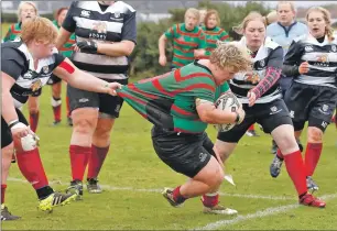  ??  ?? Ellie MacNiven barges throuogh the Kelso defence for a try.