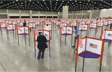  ?? Timothy D. Easley / Associated Press ?? Voting stations are spread out inside the Kentucky Exposition Center in Louisville for the June primary election. The November general election is coming with a big price tag due to the coronaviru­s pandemic.