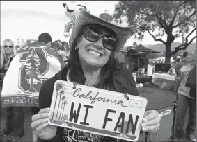  ?? RICK WOOD/MILWAUKEE JOURNAL SENTINEL FILE PHOTOGRAPH ?? Kerri Martin, originally from Waukesha, Wis., now living in San Francisco, shows off her license plate showing support for the Badgers, as she tailgates with friends before the 99th Rose Bowl game between the University of Wisconsin and Stanford...