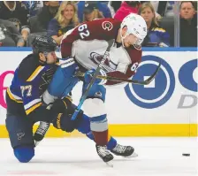  ?? DILIP VISHWANAT/GETTY IMAGES ?? St. Louis defenceman Niko Mikkola battles with Colorado Avalanche forward Artturi Lehkonen in the second period at Enterprise Center on Friday in St Louis, Mo.