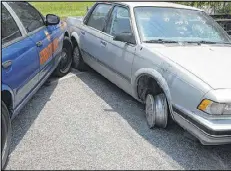  ??  ?? Caroline Small, shown in a family photo, died in a 2010 police shooting. This GBI crime scene photo shows the car driven by Small. Police fired eight bullets through her windshield as her vehicle was pinned and had nowhere to go.